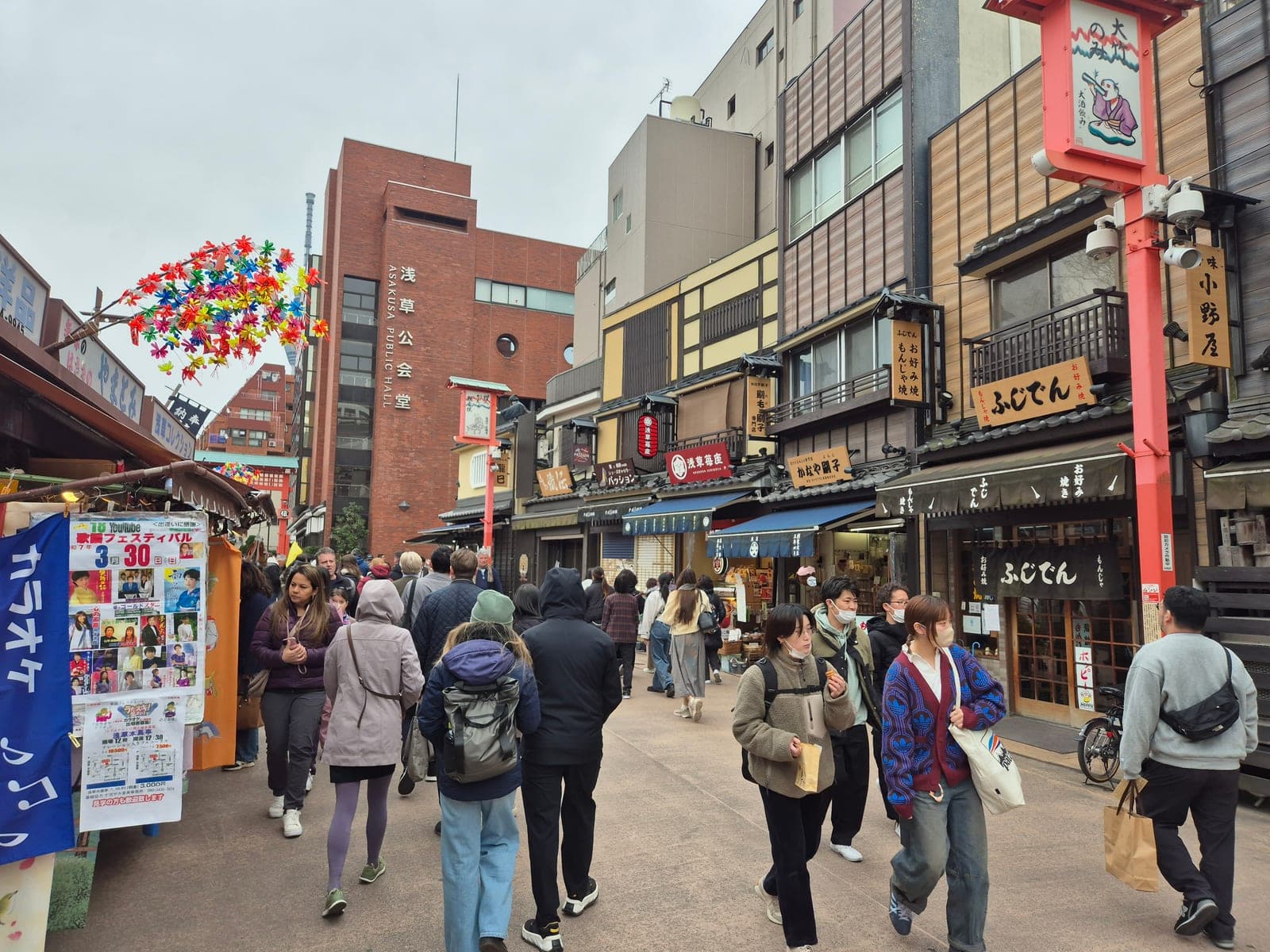 La calle comercial de Asakusa en Tokio llena de gente, con tiendas tradicionales de madera camino al templo Sensō-ji